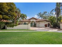 Charming single-Gathering home with lush landscaping, a tile roof, a well-manicured lawn and a two-car garage at 4946 Brywill Cir, Sarasota, FL 34234