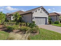 Single-story home with gray garage door and landscaping at 5824 Semolino St, Nokomis, FL 34275