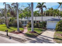 Charming single story home with a brick walkway, lush landscaping, and a two-car garage at 118 24Th W St, Bradenton, FL 34205