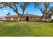 Brick house with a large front yard and mature trees at 2957 Wilderness E Blvd, Parrish, FL 34219