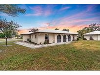 Charming single-story home featuring neutral stucco, arched doorways, and well-maintained landscaping at 430 Botticelli Dr # 430, Nokomis, FL 34275