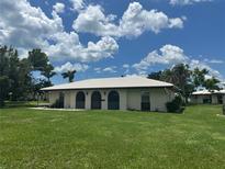 Charming single-story home with a white tile roof and well-maintained landscaping at 430 Botticelli Dr # 430, Nokomis, FL 34275