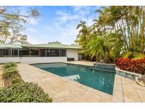 Inviting pool area with spacious patio and lush landscaping at 245 Willow Ave, Anna Maria, FL 34216