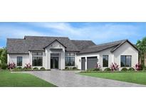 Single-story home with gray roof, white siding, and a three-car garage at 2417 Waterfront Cir, Sarasota, FL 34240