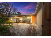 Inviting front yard with walkway, landscaping, and shade sail at 6308 Lilac Pl, Sarasota, FL 34231