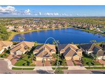 Stunning aerial view of a lakefront community with beautiful homes and lush landscaping at 21620 Avon Park Ct, Venice, FL 34293