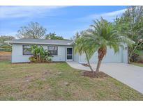 Charming one-story home featuring a well-manicured lawn and inviting curb appeal at 2551 W Burr Oak Ct, Sarasota, FL 34232