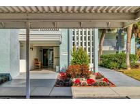 Inviting condo entrance with well-kept landscaping and covered walkway at 3300 S Beneva Rd # 224, Sarasota, FL 34232