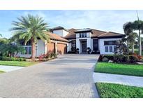 Stunning two-story home with a long driveway and well manicured landscaping at 5305 Brookgrove Dr, Sarasota, FL 34238