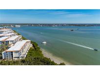 A breathtaking waterfront view of a condo community with boats sailing on the ocean at 1751 Beach Rd # 404, Englewood, FL 34223