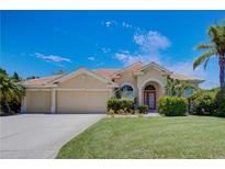 Charming single-story home with a tile roof, lush landscaping, and an attached three-car garage at 644 Rivendell Blvd, Osprey, FL 34229