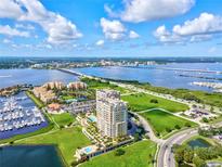 Stunning aerial view of waterfront property, showcasing the building, marina, and surrounding cityscape at 130 Riviera Dunes Way # 1104, Palmetto, FL 34221