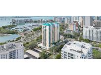 Stunning aerial view of a luxury high-rise condo building with views of the bay and the cityscape at 340 S Palm Ave # Pl1, Sarasota, FL 34236