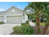 Charming single-story home with a well-manicured lawn, attached garage, and tasteful landscaping at 3922 Wildgrass Pl, Parrish, FL 34219
