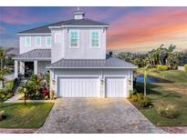 Beautiful two-story home with a two-car garage and a brick driveway near lush landscaping and waterfront at 5204 Title Row Dr, Bradenton, FL 34210