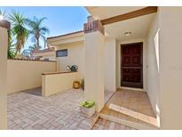 Charming front porch featuring brick flooring and a secure, decorative front door at 5343 Huntingwood Ct # 33, Sarasota, FL 34235