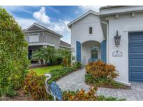 Charming home with well-maintained landscaping, paver walkway, and blue shutters providing an inviting curb appeal at 12810 Seasong Ter, Bradenton, FL 34211