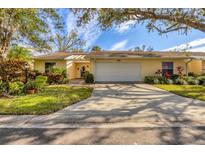 Charming one-story home with a two-car garage, well-maintained lawn, and beautiful landscaping at 4045 Oakhurst Dr # 3125, Sarasota, FL 34233