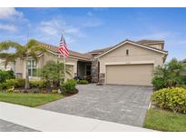 Charming single-Gathering home with lush landscaping, paver driveway, and neutral paint scheme at 20296 Bandera Pl, Venice, FL 34293
