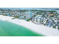 Stunning aerial view of a beachfront condo complex with pristine white sand and turquoise waters at 800 Benjamin Franklin Dr # 602, Sarasota, FL 34236