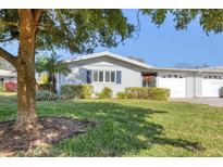 Charming single-story home featuring well-maintained landscaping, a lovely green lawn, and decorative shutters at 7304 11Th W Ave, Bradenton, FL 34209
