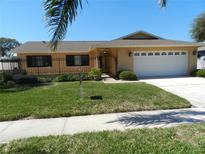 Charming single Gathering home featuring a well-maintained lawn and wrought iron fence at 9400 Ridge Rd, Seminole, FL 33772