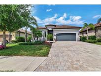 Beautiful single-Gathering home with a well-manicured lawn and a spacious driveway leading to an attached two-car garage at 17601 Hickok Belt Loop, Bradenton, FL 34211