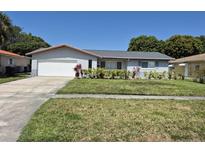 Charming single-story home featuring a well-manicured lawn and an attached two-car garage at 2098 35Th N St, St Petersburg, FL 33713