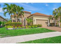 Charming single-Gathering home featuring a well-maintained lawn, lovely landscaping, and a two-car garage at 3904 Waypoint Ave, Osprey, FL 34229
