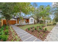 Charming white craftsman home featuring professional landscaping, quaint front porch, and inviting walkway at 4536 1St N Ave, St Petersburg, FL 33713