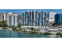 Modern high-rise condo building featuring sleek architectural lines, glass balconies, and stunning waterfront views at 1155 N Gulfstream Ave # 607, Sarasota, FL 34236