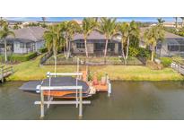 Waterfront property featuring a private boat lift, dock, and screened patio with beautiful water views at 5125 Tidewater Preserve Blvd, Bradenton, FL 34208