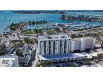 Stunning aerial view of waterfront condo building near the marina and bay, offering beautiful cityscape views at 101 S Gulfstream Ave # 16J, Sarasota, FL 34236