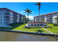 Beautiful waterfront condo community with lush landscaping and a view of the water at 1600 1St W Ave # 304A, Bradenton, FL 34205