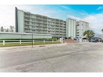 Spacious condominium building featuring a well-maintained exterior, balconies, and convenient parking at 5200 Gulf Dr # 601, Holmes Beach, FL 34217