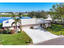 Beautiful waterfront home with lush landscaping and a long driveway at 6420 13Th Avenue W Dr, Bradenton, FL 34209