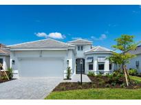 Charming single-story home with a two-car garage, well manicured landscaping, and a neatly paved walkway at 8024 Moonbeam Ave, Sarasota, FL 34241