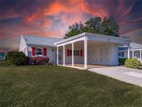 Charming single-story home with a covered parking area and vibrant red window shutters at 4714 Potomac Cir, Bradenton, FL 34210