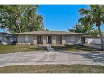 Charming single-story home with a circular driveway and well-manicured lawn, great curb appeal at 5445 Bahia Vista St, Sarasota, FL 34232