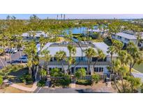 Beautiful waterfront property featuring lush landscaping and serene water views at 6750 Gulf Of Mexico Dr # 153, Longboat Key, FL 34228