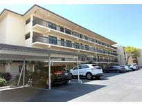Multi-level condo building showing parking area and black iron railings at 515 30Th W Ave # H207, Bradenton, FL 34205