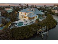 Stunning coastal home with a private pool, dock, and picturesque water views at 114 Gull Dr, Anna Maria, FL 34216