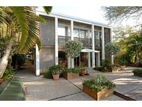 Stunning two-story modern home with meticulous landscaping, a patio, and unique architectural details at 3721 Flamingo Ave, Sarasota, FL 34242