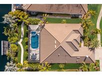 Stunning aerial view of a home with a screened pool, lush landscaping, and a tile roof at 579 Fore Dr, Bradenton, FL 34208