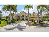 Stunning home featuring a manicured front yard, beautiful landscaping and a circular driveway at 13616 Legends Walk Ter, Lakewood Ranch, FL 34202