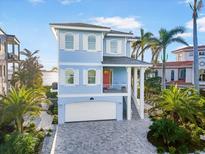 Inviting two-story home with a paved driveway and a two-car garage at 12917 42Nd W Ter, Cortez, FL 34215