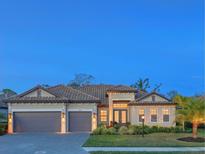 Charming home featuring a tile roof, neutral paint, well-manicured lawn, and a two car garage at 16125 Tradewind Ter, Lakewood Ranch, FL 34211