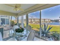 Bright dining area featuring a glass table and picturesque waterfront views from large windows at 4350 Chatham Dr # E106, Longboat Key, FL 34228