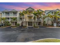 Beautiful condo building with palm trees and private garages in desirable community at 559 Bahia Beach Blvd, Ruskin, FL 33570