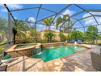 Screened-in pool and spa area featuring waterfall features and lush landscaping for a private oasis at 5116 Tivoli Run, Bradenton, FL 34211